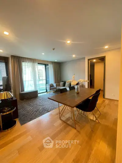 Spacious modern living room with elegant dining area and large windows for natural light.