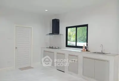 Modern minimalist kitchen with sleek cabinetry and gas stove