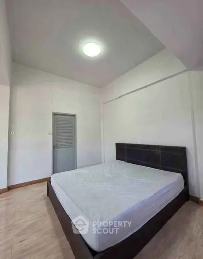 Spacious bedroom with minimalist design and natural light