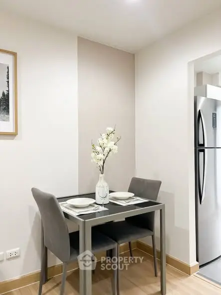 Cozy dining nook with modern table and chairs in a stylish apartment kitchen.