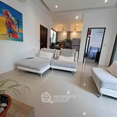 Modern living room with stylish furniture and open kitchen layout