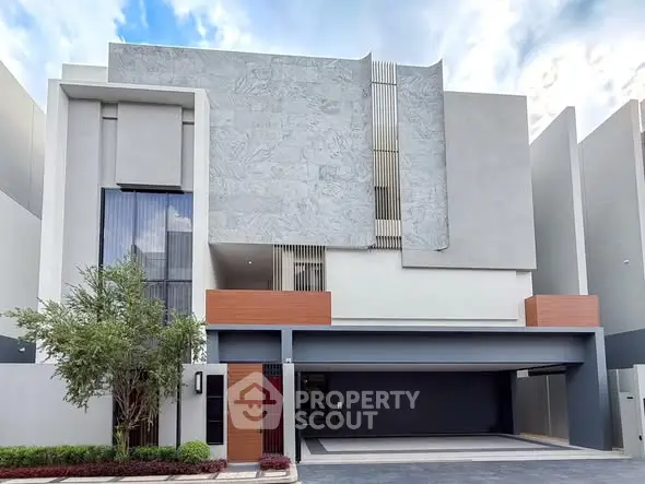 Modern minimalist building exterior with sleek design and spacious garage.