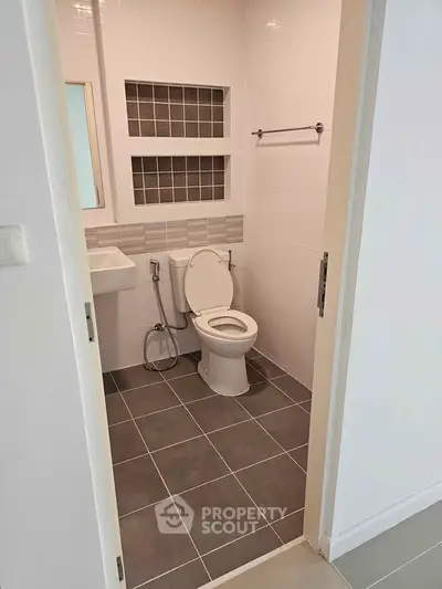 Modern bathroom with sleek tile design and compact layout