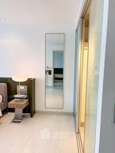 Modern bedroom with sleek design and full-length mirror