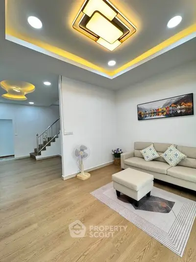 Modern living room with stylish ceiling lights and cozy seating area