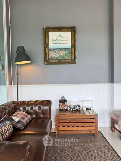 Charming living room with leather sofa and rustic decor, perfect for cozy gatherings.