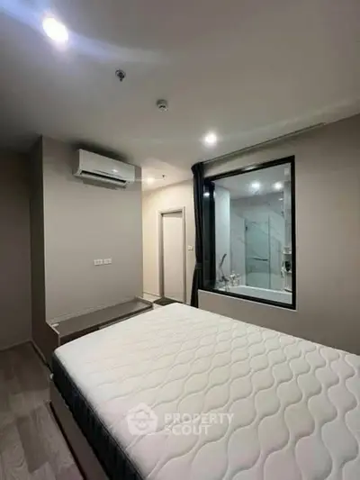 Modern bedroom with large window and air conditioning unit
