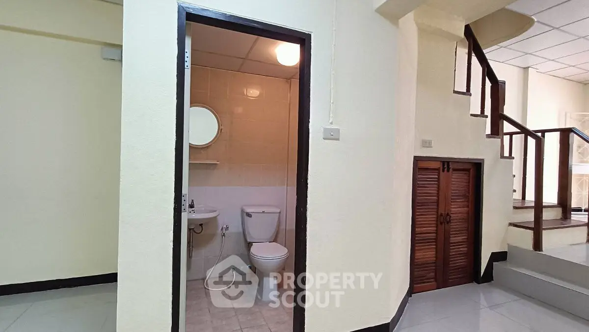 Cozy interior with bathroom and staircase, ideal for compact living spaces.