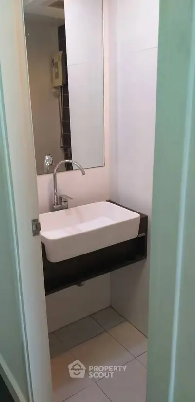 Compact bathroom with modern sink and mirror in a cozy apartment