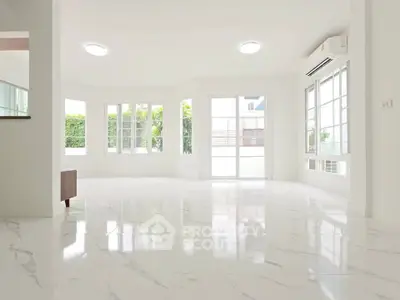 Spacious bright living room with marble flooring and large windows