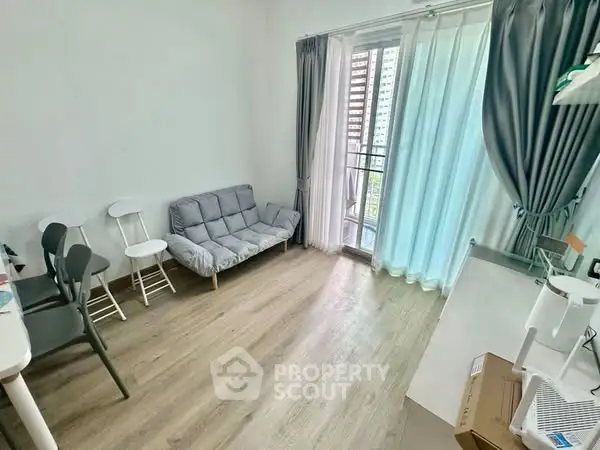 Bright living room with balcony access and modern decor