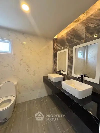 Modern bathroom with dual sinks and elegant marble tiles