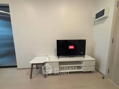 Modern living room with sleek TV setup and minimalist furniture design.