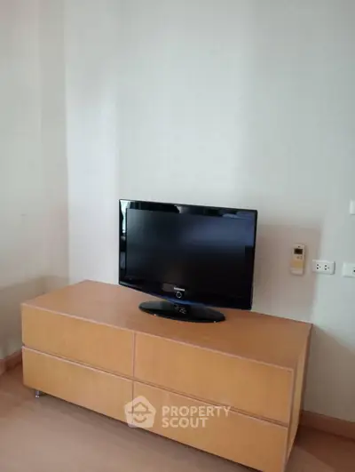Modern living room with sleek TV setup on wooden cabinet