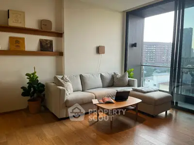 Modern living room with cozy sofa and balcony view in urban apartment