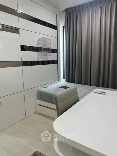 Modern minimalist bedroom with sleek furniture and large window curtains