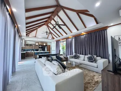 Luxurious open-plan living room with high ceilings and modern decor