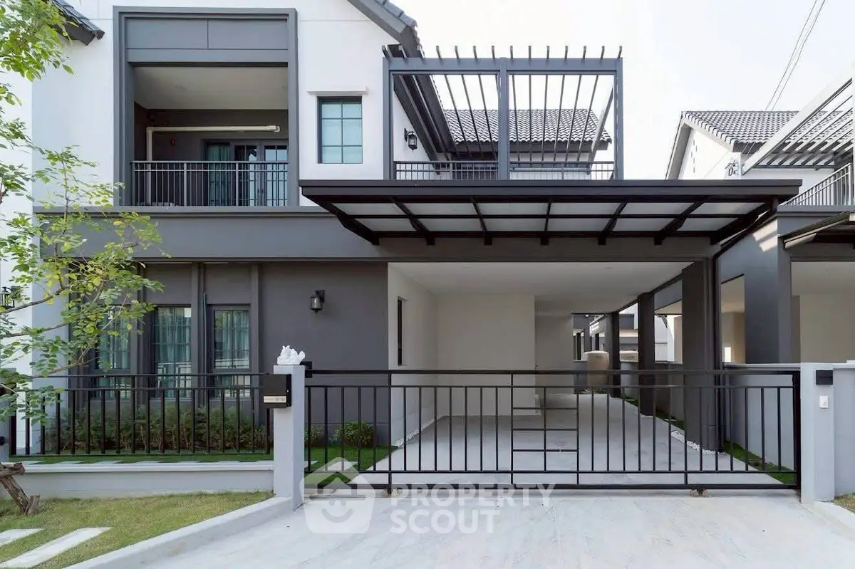 Modern two-story house with sleek design and spacious driveway in a serene neighborhood.