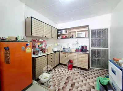 Charming kitchen with vibrant orange fridge and ample storage space.