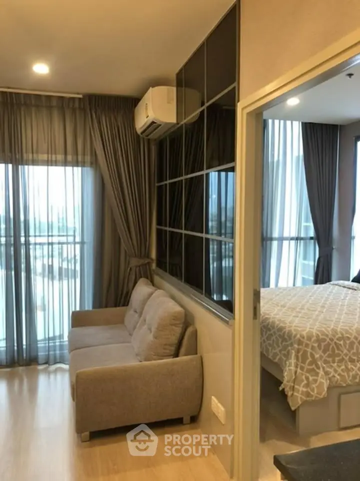 Modern apartment interior with cozy living room and stylish bedroom, featuring floor-to-ceiling windows and elegant decor.