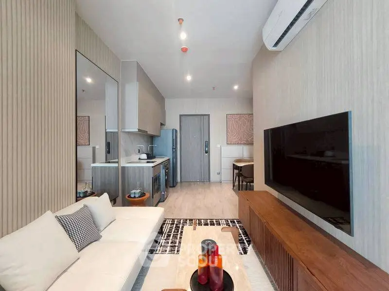 Modern living room with sleek furniture and open kitchen layout