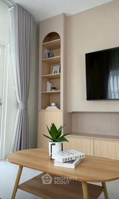 Modern living room with stylish wooden furniture and built-in shelving