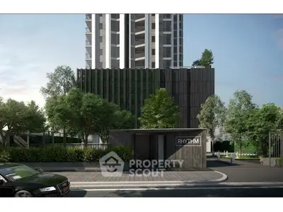 Modern high-rise building with lush greenery and sleek entrance, ideal for urban living.
