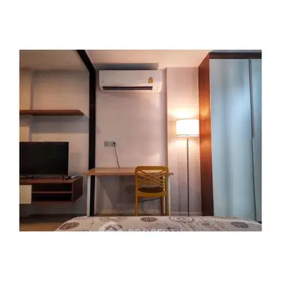 Modern bedroom with air conditioning, TV, and stylish decor