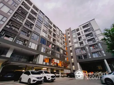 Modern apartment building with parking area and contemporary design