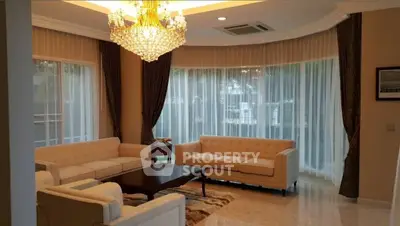 Luxurious living room with elegant chandelier and large windows