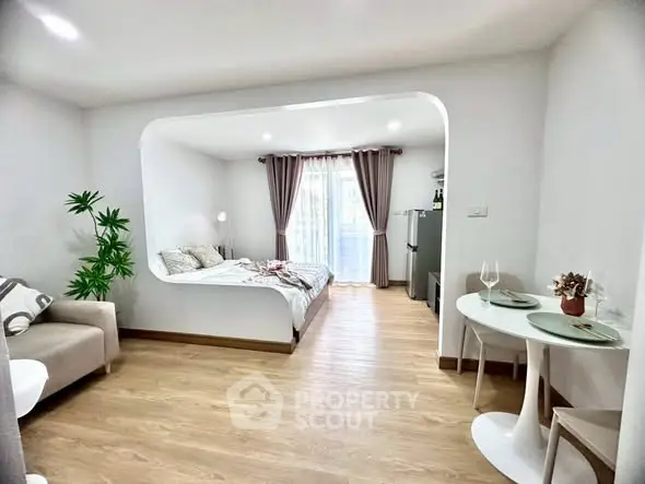 Modern studio apartment with open layout, featuring cozy bedroom, stylish living area, and dining space.