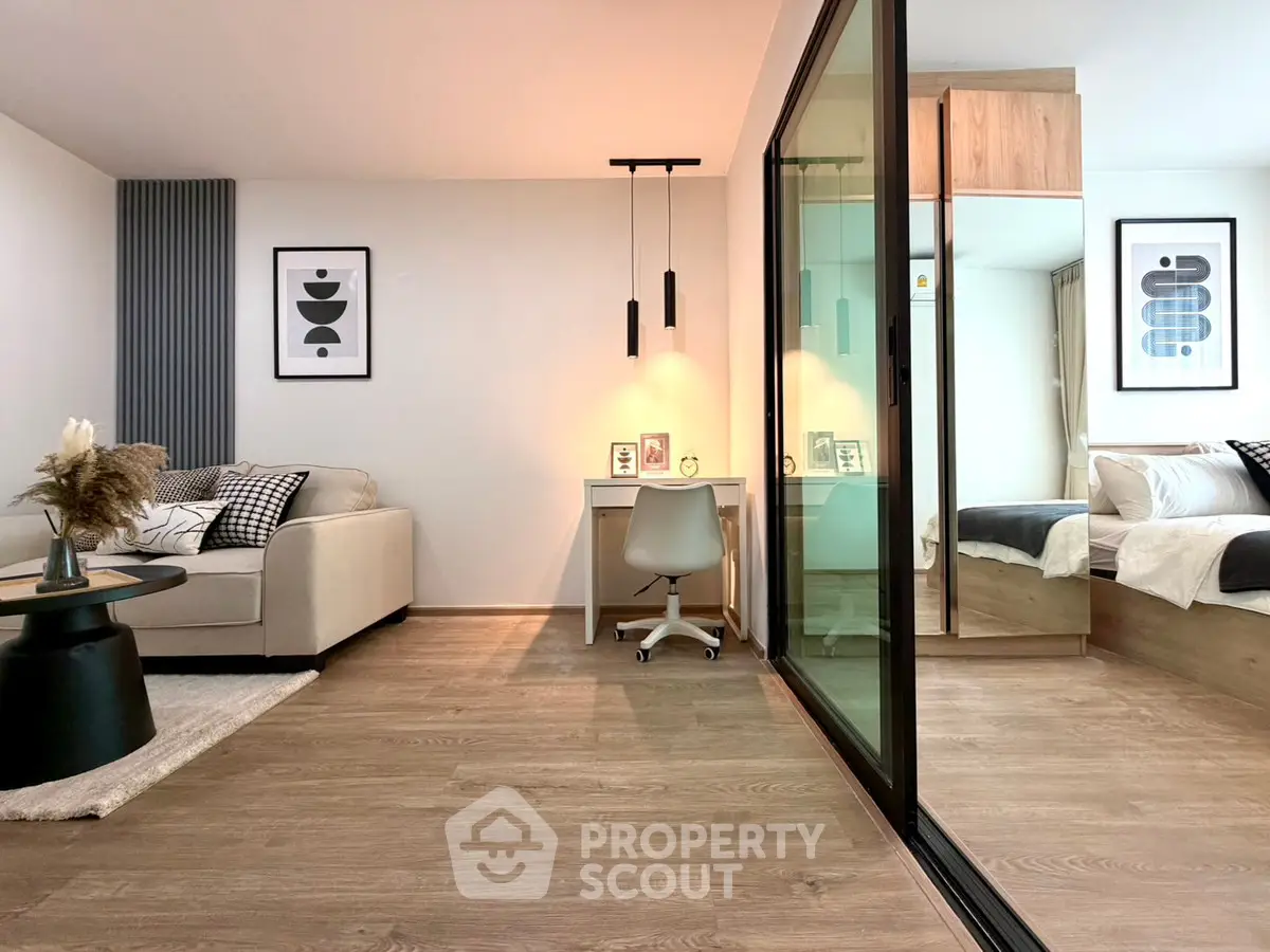 Modern open-plan living room with stylish decor and cozy bedroom view