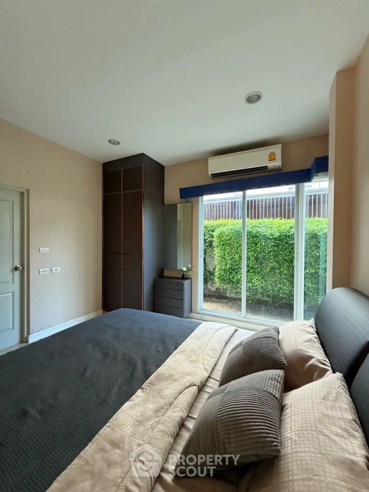 Cozy bedroom with garden view and modern furnishings