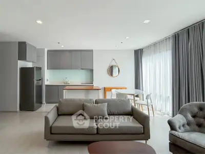Modern open-plan living room with sleek kitchen and stylish furniture
