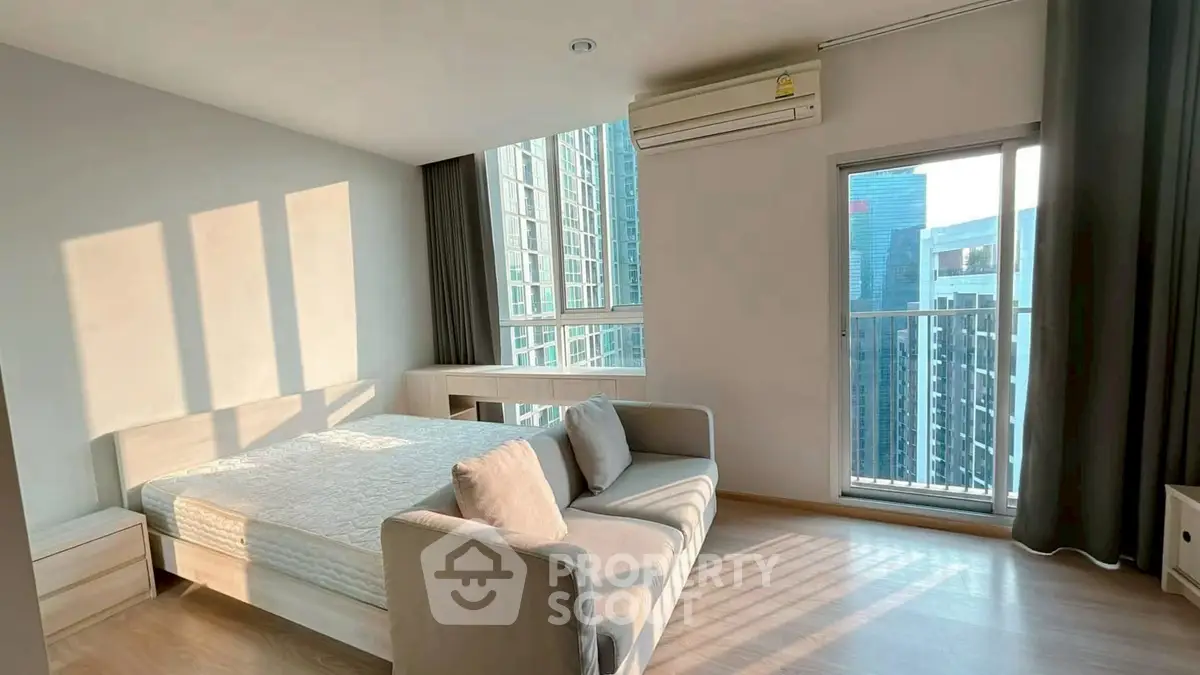 Modern bedroom with city view and natural light