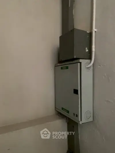 Electrical panel in a residential building corner, showcasing essential infrastructure.