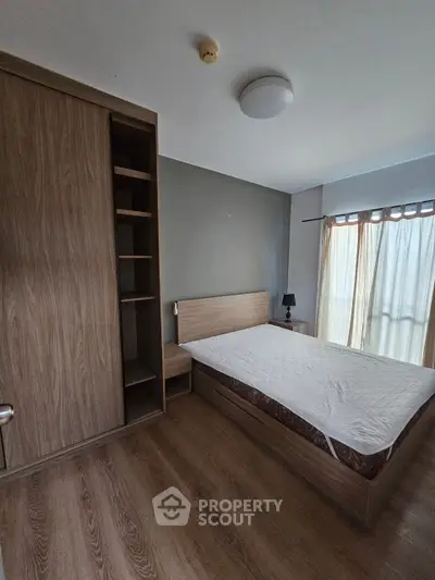 Modern bedroom with wooden flooring and built-in wardrobe