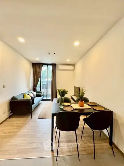 Modern living room with dining area and balcony view in stylish apartment