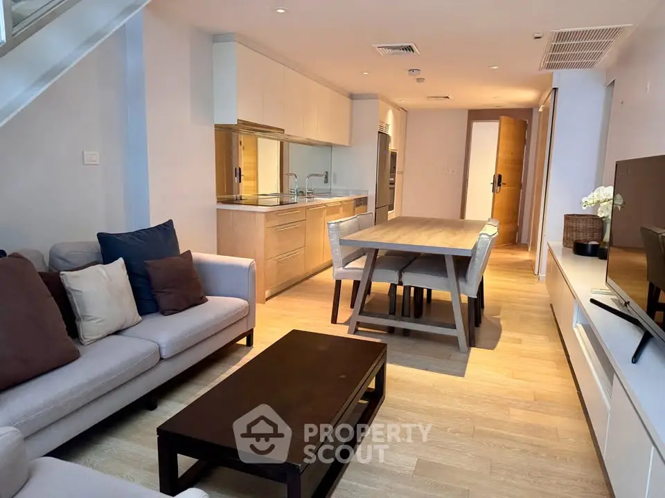 Modern open-plan living room with stylish kitchen and dining area