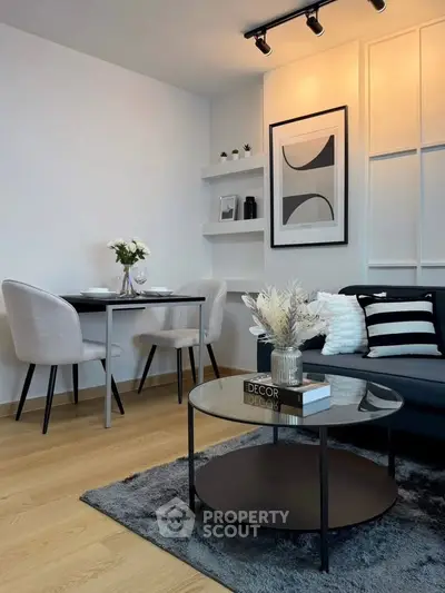 Modern living room with stylish decor, featuring a cozy seating area and elegant dining setup.