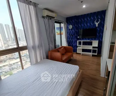 Modern bedroom with city view, stylish decor, and cozy seating area.