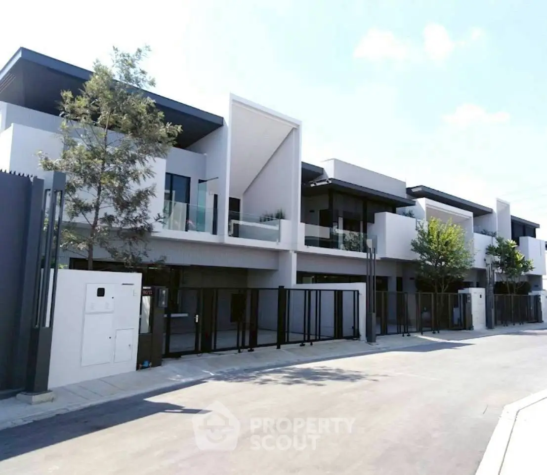 Modern townhouse complex with sleek design and spacious balconies.
