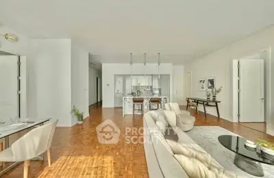 Spacious open-plan living room with modern decor and elegant dining area.