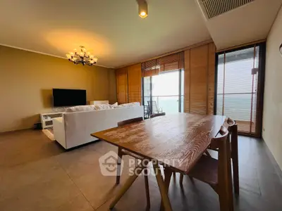 Spacious living room with modern decor and stunning ocean view.