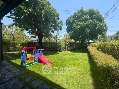 Spacious backyard with lush greenery and children's playset, perfect for family fun.
