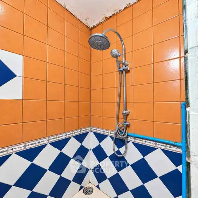 Vibrant tiled shower area with modern fixtures in a stylish bathroom.