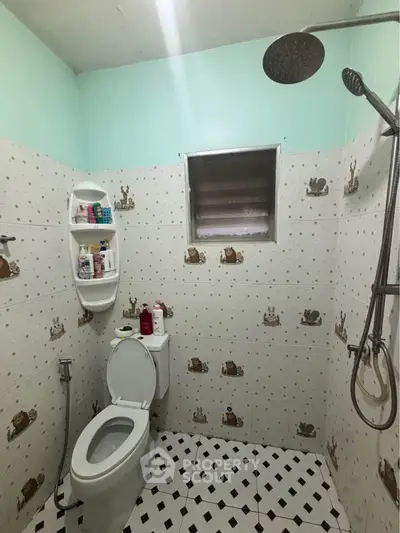 Charming bathroom with playful tile design and modern shower fixtures.