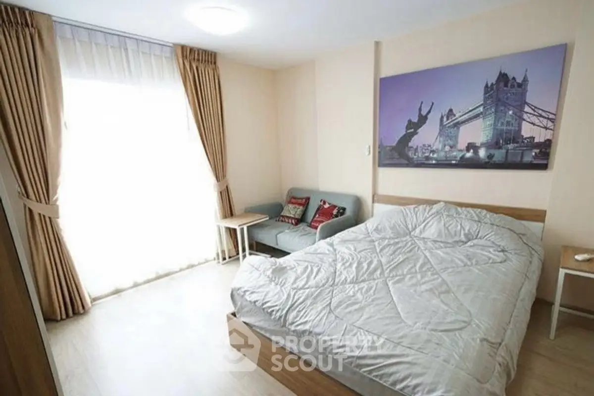 Cozy bedroom with modern decor and large window for natural light