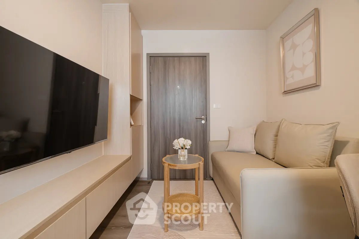Modern living room with sleek furniture and wall-mounted TV, perfect for cozy relaxation.