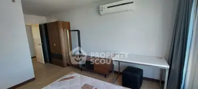 Spacious bedroom with modern furniture and air conditioning, perfect for comfortable living.